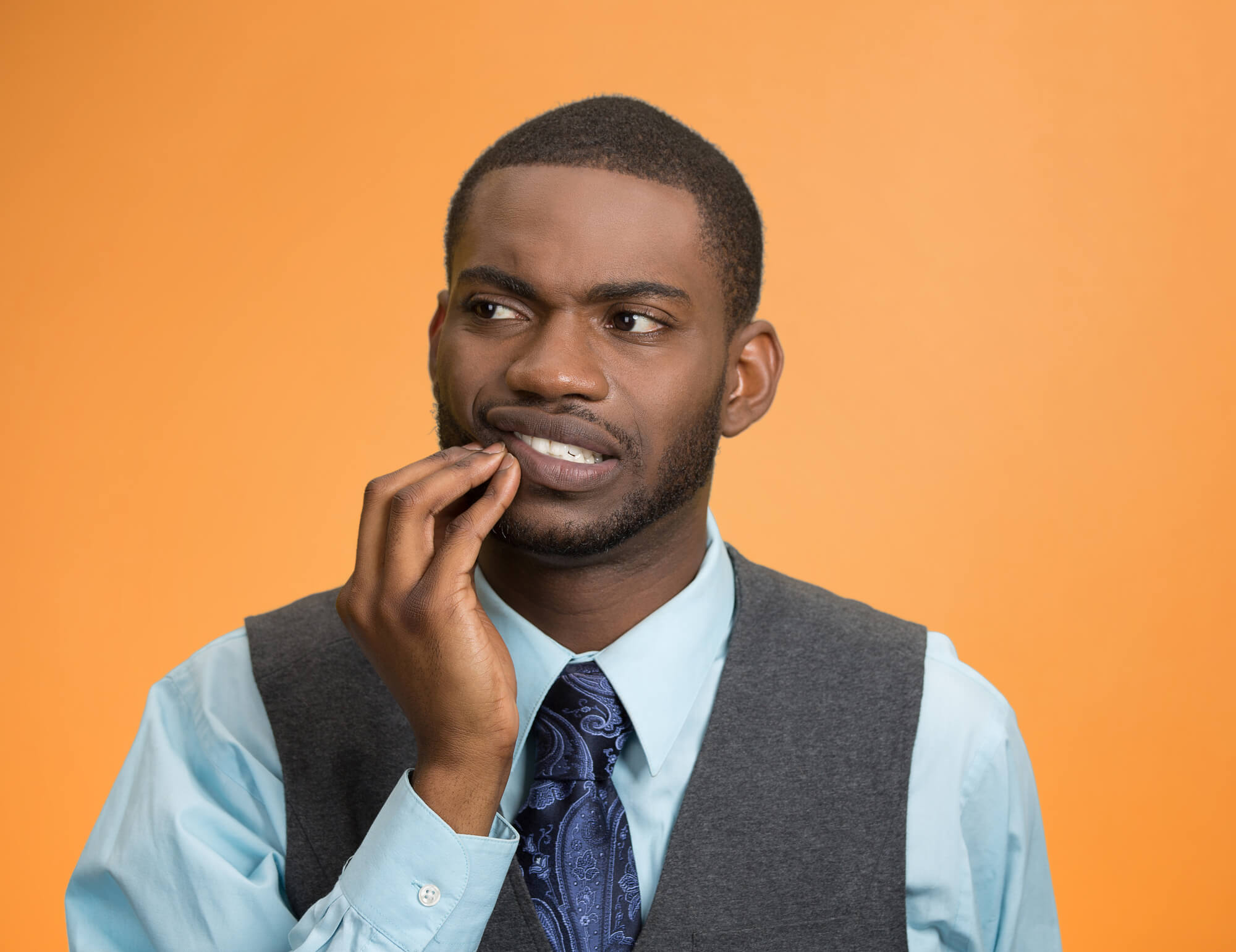 Closeup portrait handsome sad young executive man, student, worker touching face having bad pain, tooth ache